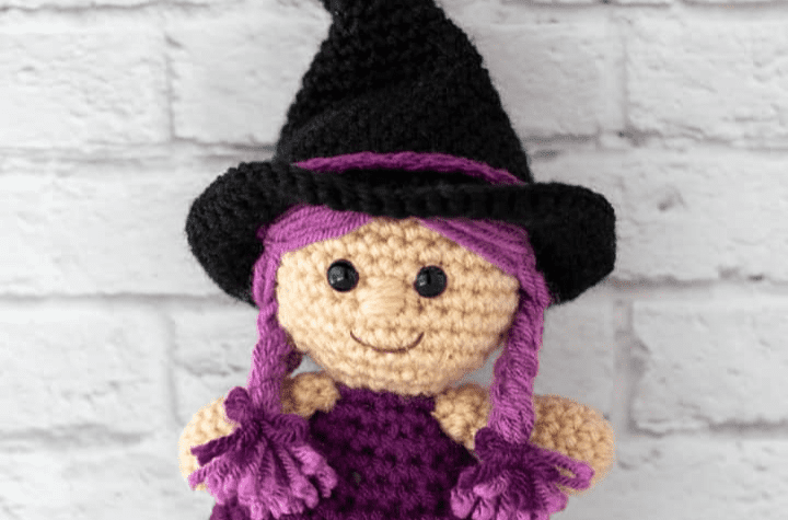 Purple crochet witch doll.