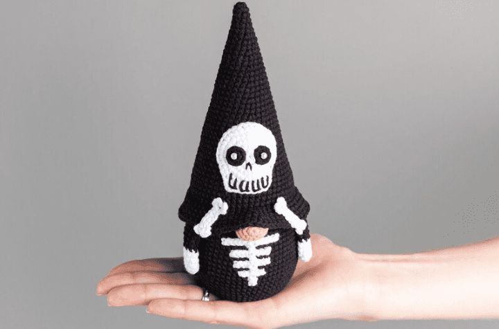 A skeleton gnome wearing all black.