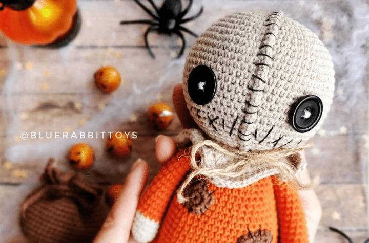 Scarecrow amigurumi with orange shirt.