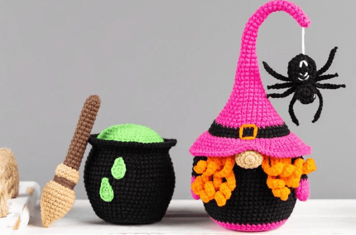 Pink witch gnome with a cauldron and a broom.