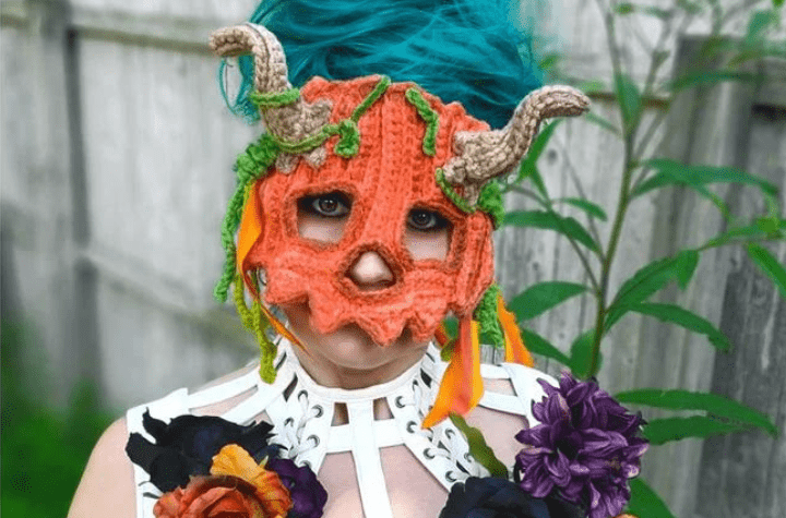 Pumpkin crochet mask witch horns.