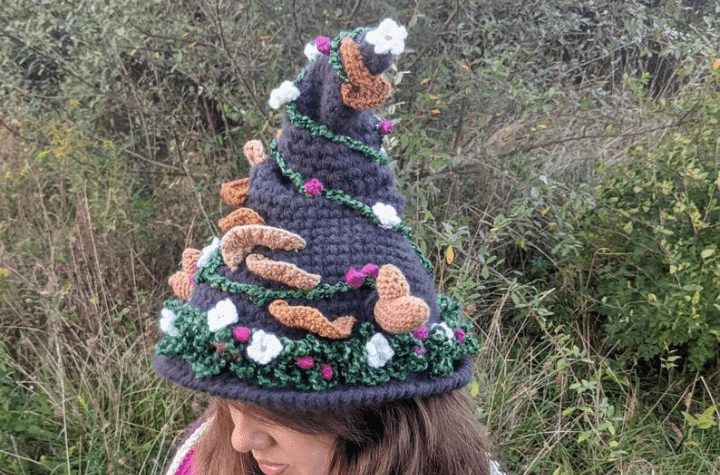 Toadstool inspired witch hat with a variety of mushrooms decorating the hat.