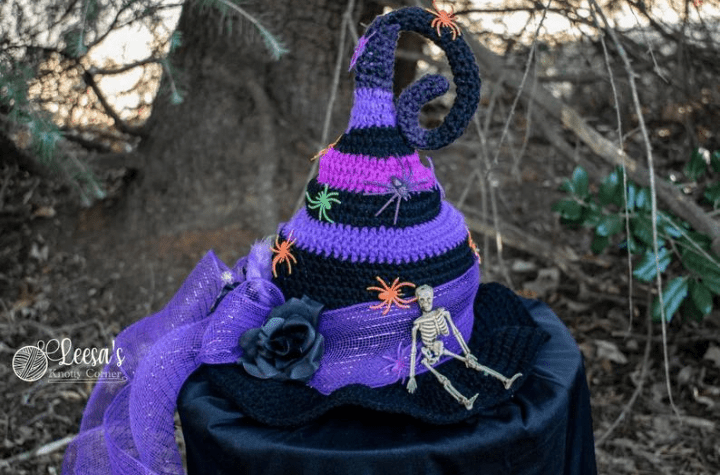 Black and purple twisted crochet witch hat with little plastic spiders.