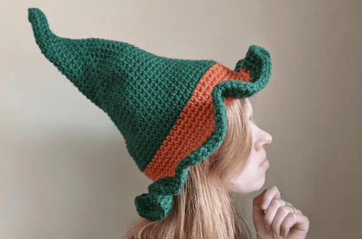 Green hat with an orange splash of color.