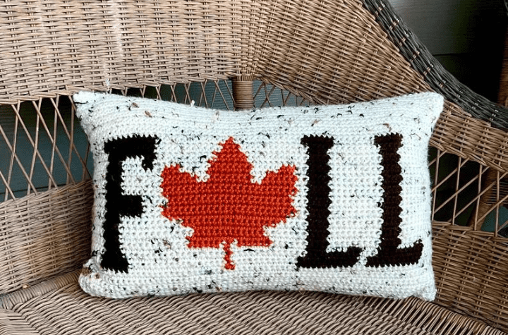 Pillow that says "Fall" but with a maple leaf where the "a" would be.
