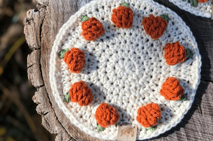 Round coaster with tiny crochet pumpkins.