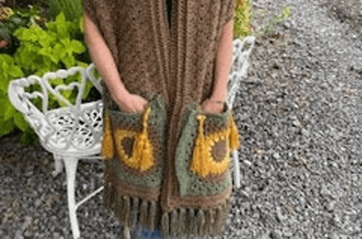 Brown crochet pocket shawl with sunflower pockets.