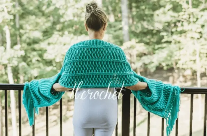 Blue crochet shawl with pockets.