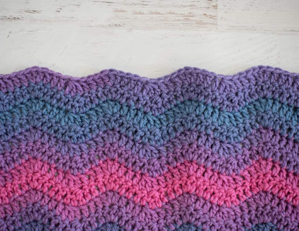 wavy edge of purple, pink and blue ripple stitch baby afghan