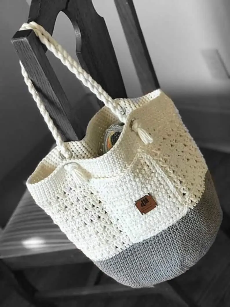 Gray and white crochet bag on chair