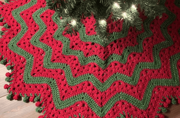 Green and red tree skirt with star-shaped edges.