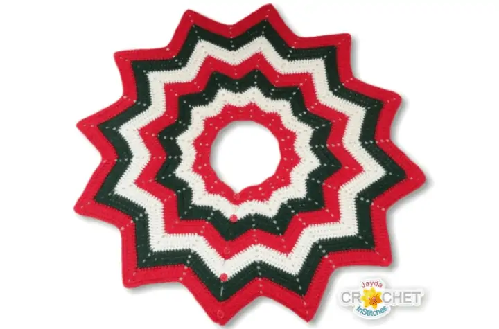 A 12-pointed star tree skirt in red, white, and green.