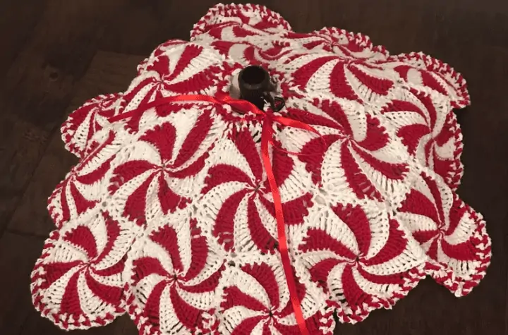a tree skirt featuring a bunch of little peppermint circles.