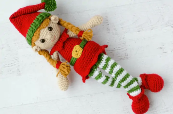 Crochet amigurumi elf pattern, with green white and white stockings and a little elf hat.