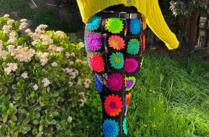 colorful crochet pants made out of granny squares with a black background.