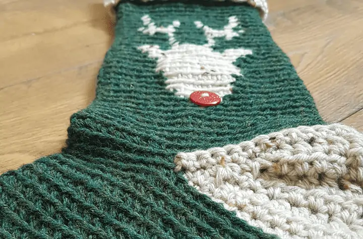 green stocking with a reindeer on it.