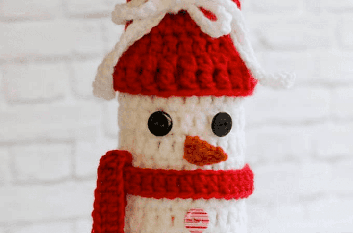 Snowman wine cozy with a red scarf.