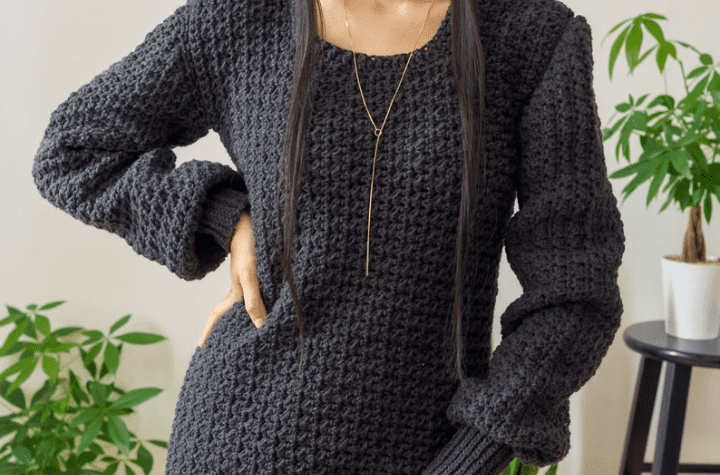Black crochet sweater dress with puffy sleeves.