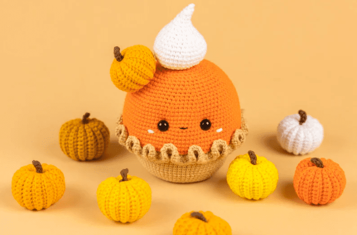 Amigurumi pumpkin pie with a dollop of whipped cream and a little pumpkin.