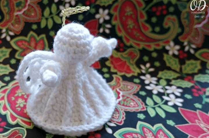 A simple crochet angel ornament with a gold halo.