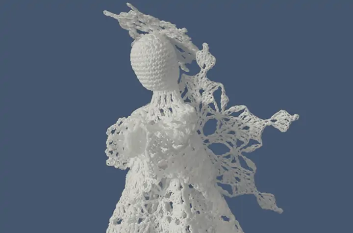 Lace crochet angel tree topper with a lace halo.