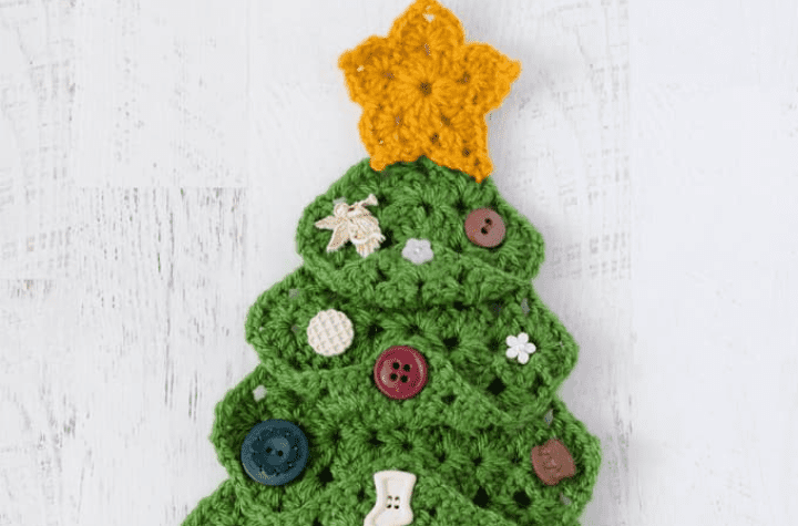 Crochet Christmas tree made out of granny squares and different buttons as ornaments.