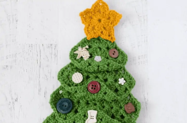Crochet Christmas tree made out of granny squares and different buttons as ornaments.