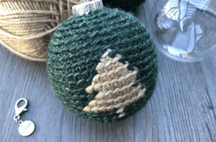 A christmas ornament with all green yarn and a white Christmas tree