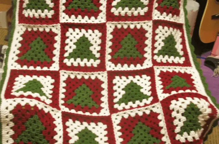 Blanket with green tree and red and white backgrounds for each color block.