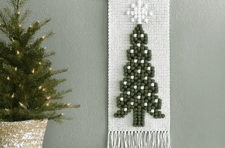 Crochet Christmas tree wall banner, using white yare and theornaments and star topper