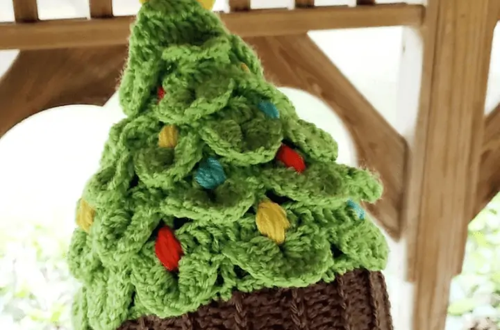 Crochet Christmas tree hat with small crochet ornaments throughout the hat.
