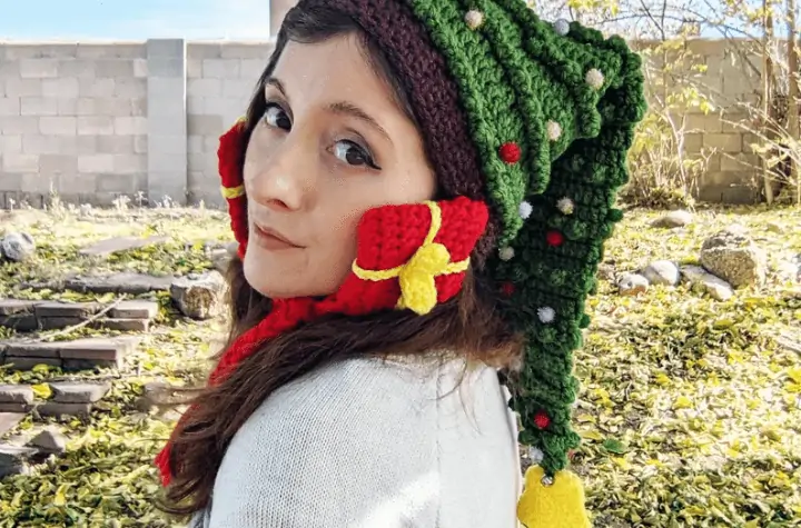 Crochet Christmas tree hat with presents over the ears as ear warmers.