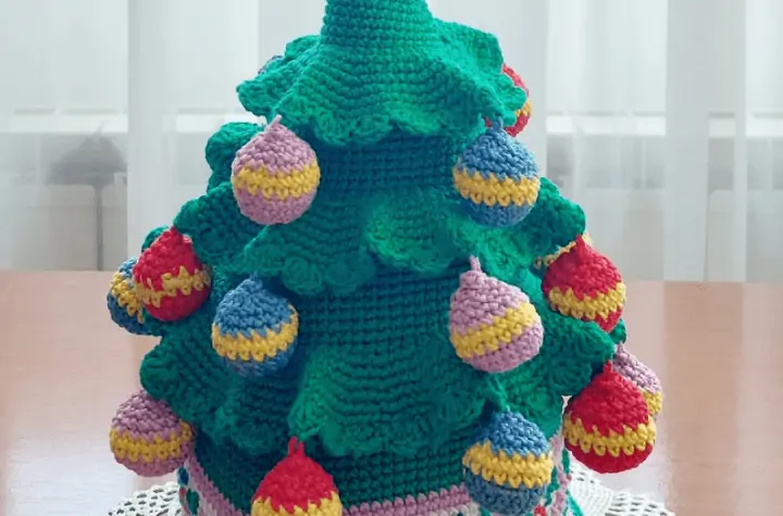 A 3D crochet Christmas Tree with large ornamments on it.