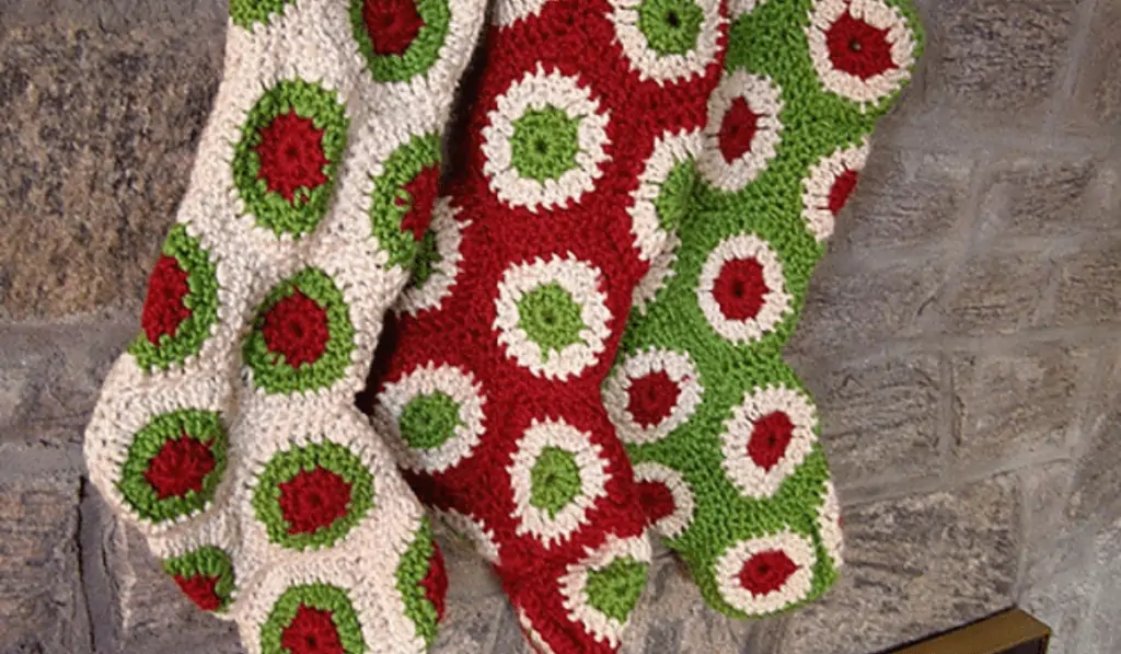 Three crochet granny stockings using green, red,and white interchangibly.