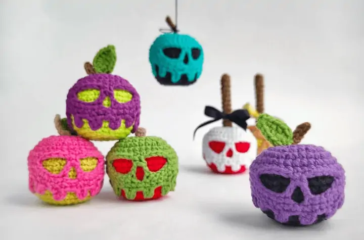Seven poision apple keychains featuring different colors fr the posion drip and apple.