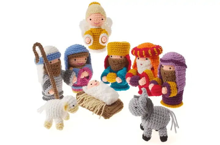 Full amigurumi nativity scene complete with the holy family, three wise men, an angel, a sheep, and a donkey.