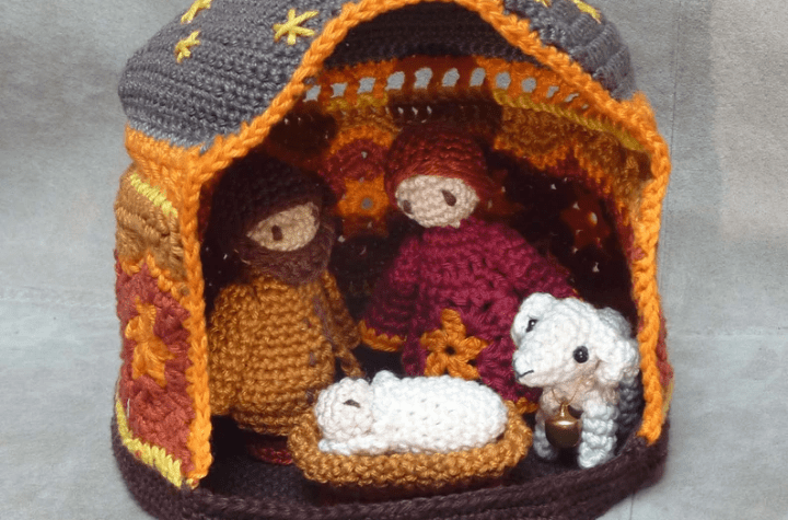 Crochet nativity set with the holy family, a shep, and a crochet manger.
