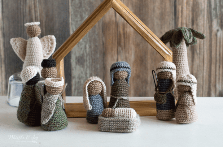 Full amigurumi natiity set with the holy family, an angel, three wise men, a shepard, and a crochet palm tree.