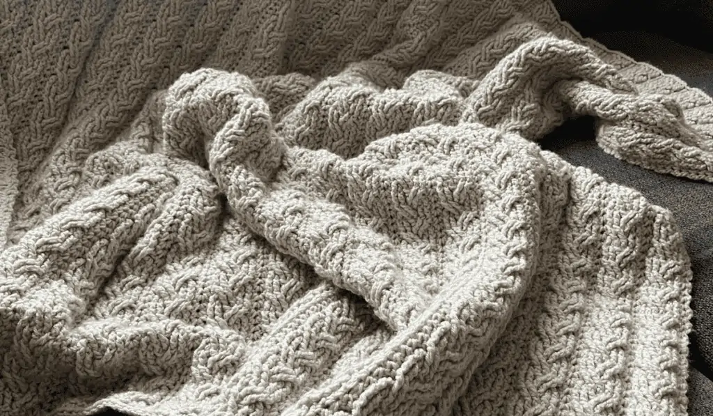 Braid-looking crochet blanket using white yarn.