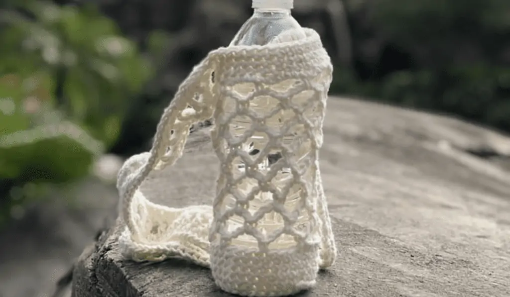Crochet water bottle holder made out of white yarn.