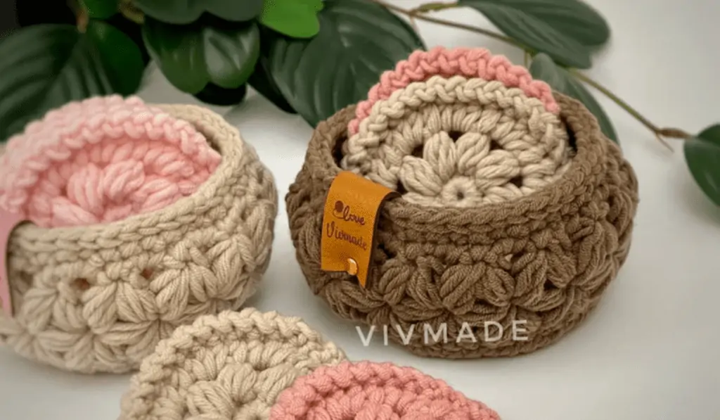Pink and beige crochet face scrubbies in a brown mini basket.