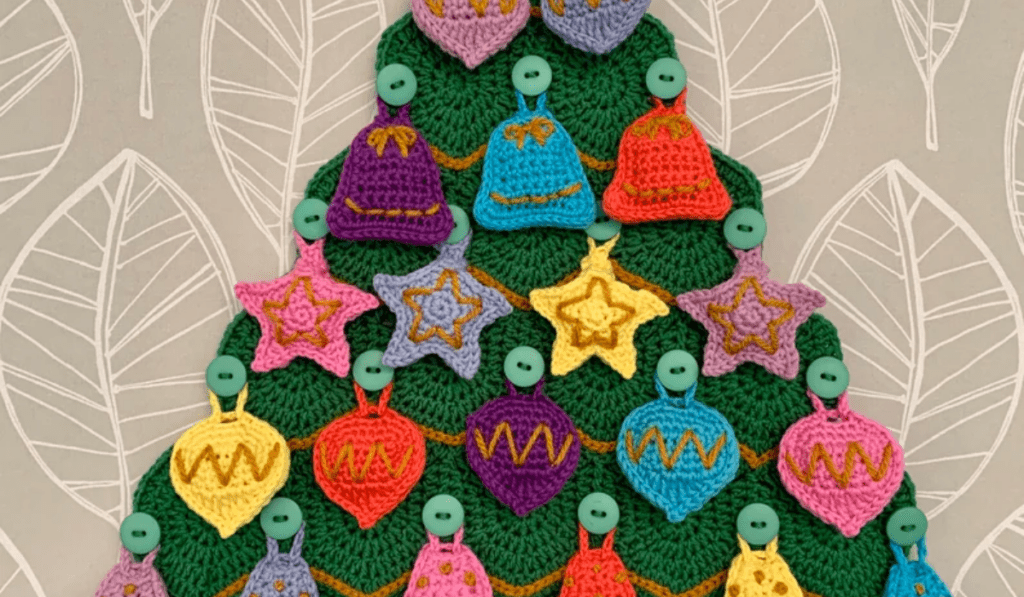 Crochet Christmas tree advent calendar with multicolored ornaments.
