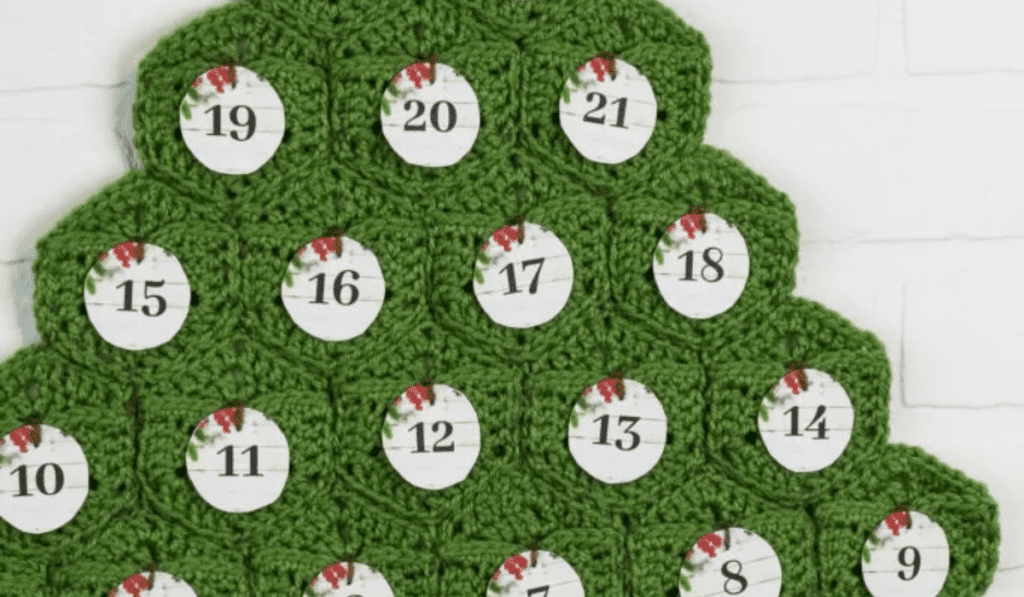 A crochet pine tree with different dates and pockets to put items in.