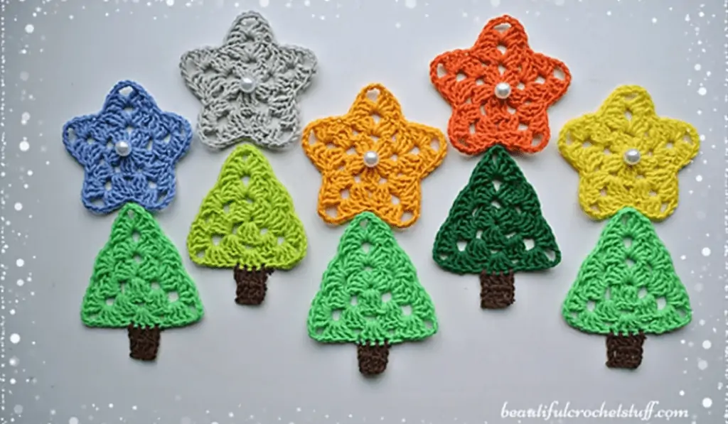 Five pine tree motifs in varying shades of green with crochet stars in blue, grey, yellow, orange, and neon yellow.