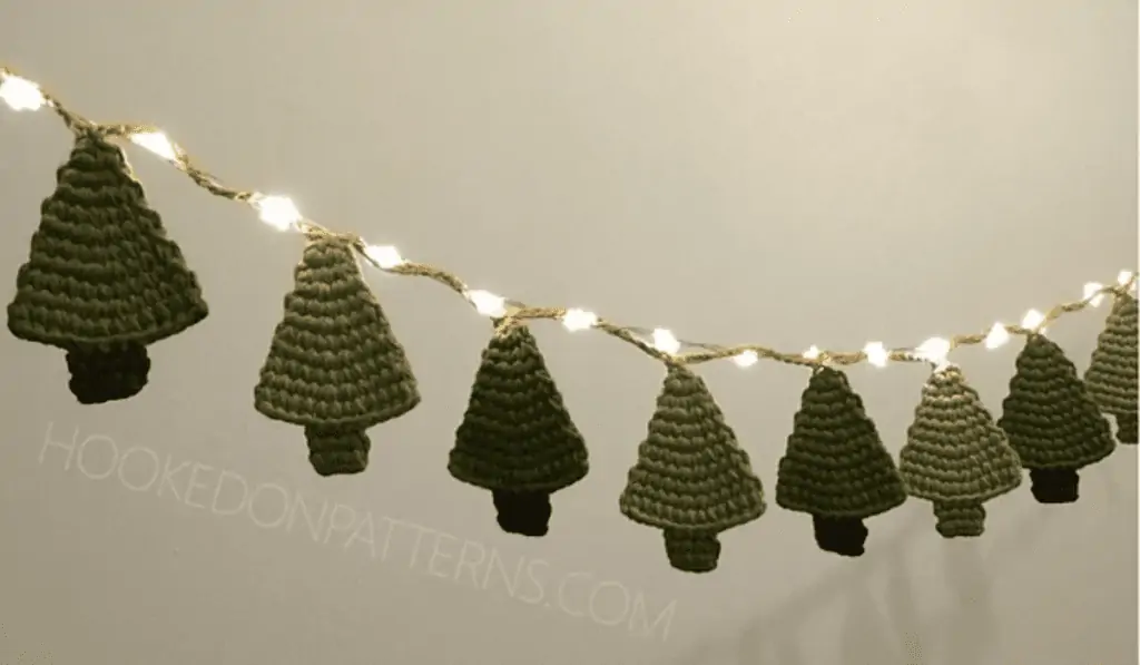 A garland of pine trees around string lights.