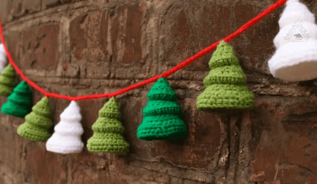 3D little pine trees on a garland in light green, dark green, and white.