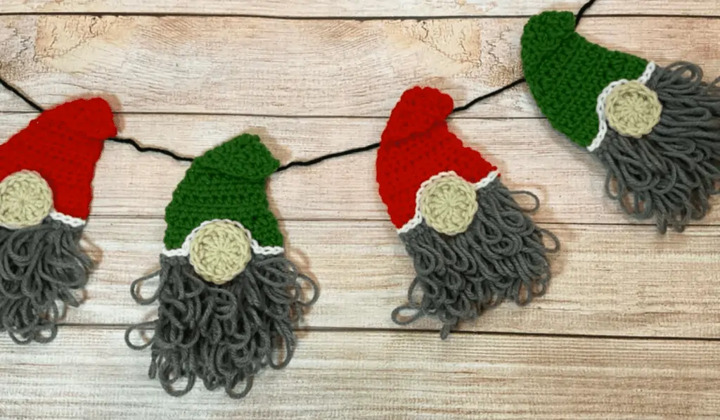A garland of 2D gnomes with red and green hats.
