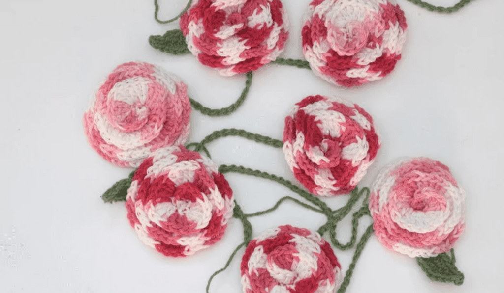 A garland of roses with swirling colors on the roses.