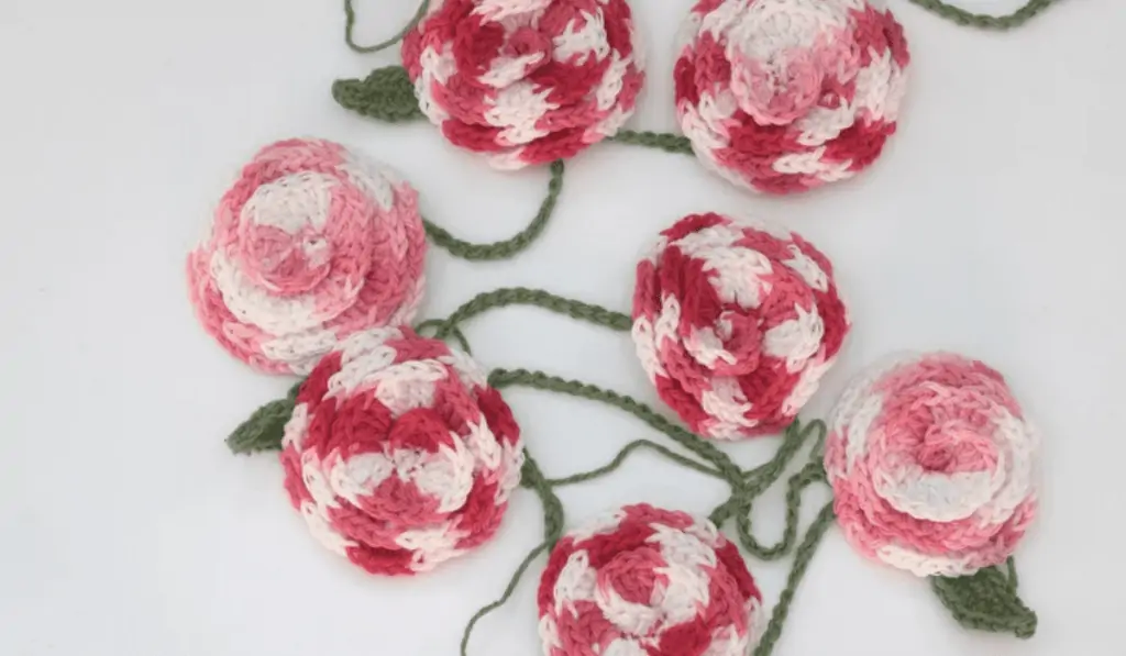 A garland of roses with swirling colors on the roses.