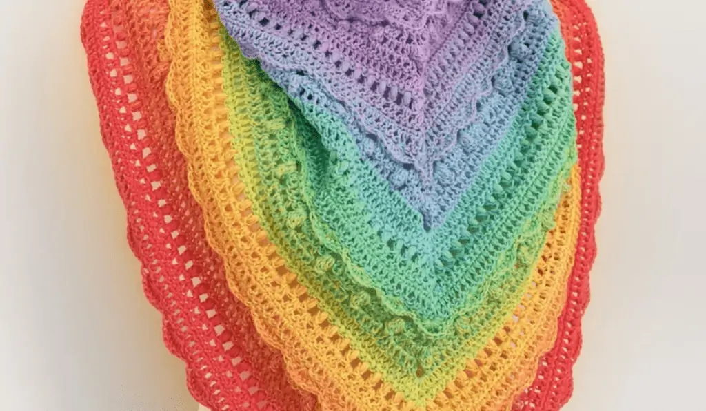 A rainbow crochet shawl with different layers for each color.